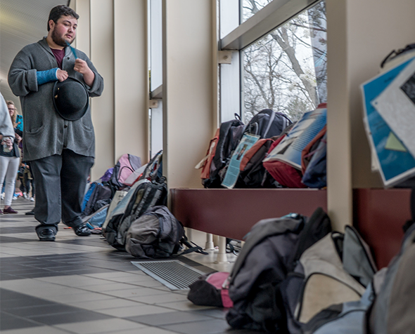 Student walking past Send Silence Packing event bringing awareness to college suicide